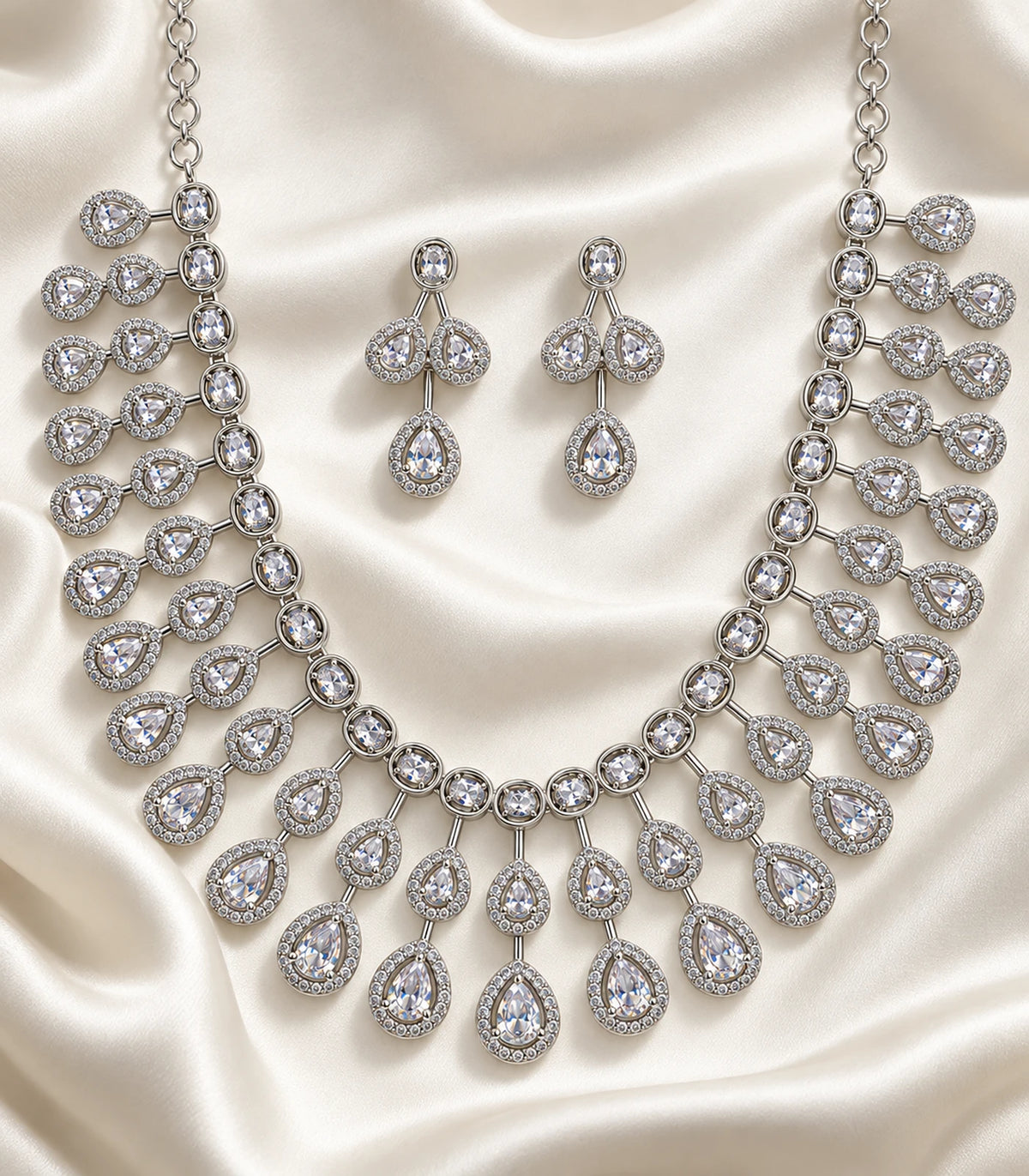 Silver Clear Teardrop Fringe Crystal Necklace Set — necklace and matching earrings in an editorial flatlay