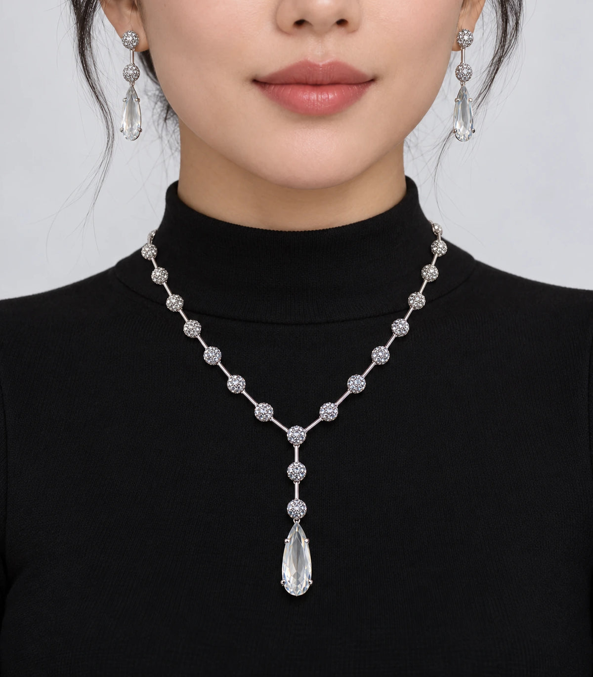 Silver Clear Y-Drop Crystal Necklace Set worn with matching earrings and a black top