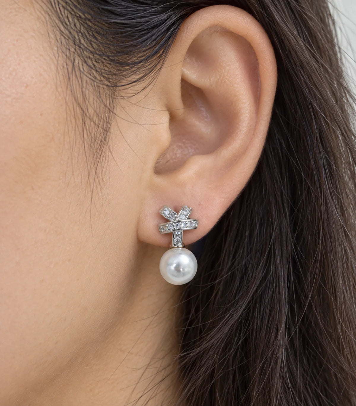 JIMIKI Silver Crystal Knot Pearl Drop Earrings - worn closeup #color_silver