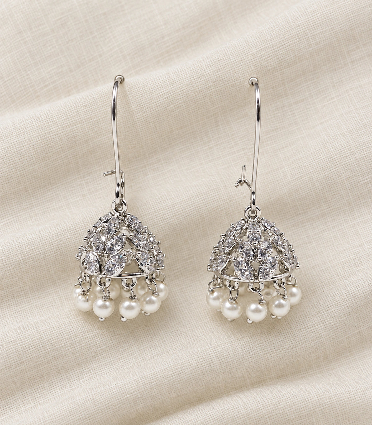JIMIKI Crystal Leaf Pearl Hoop Jhumka Earrings - Silver pair in a styled flatlay #color_silver