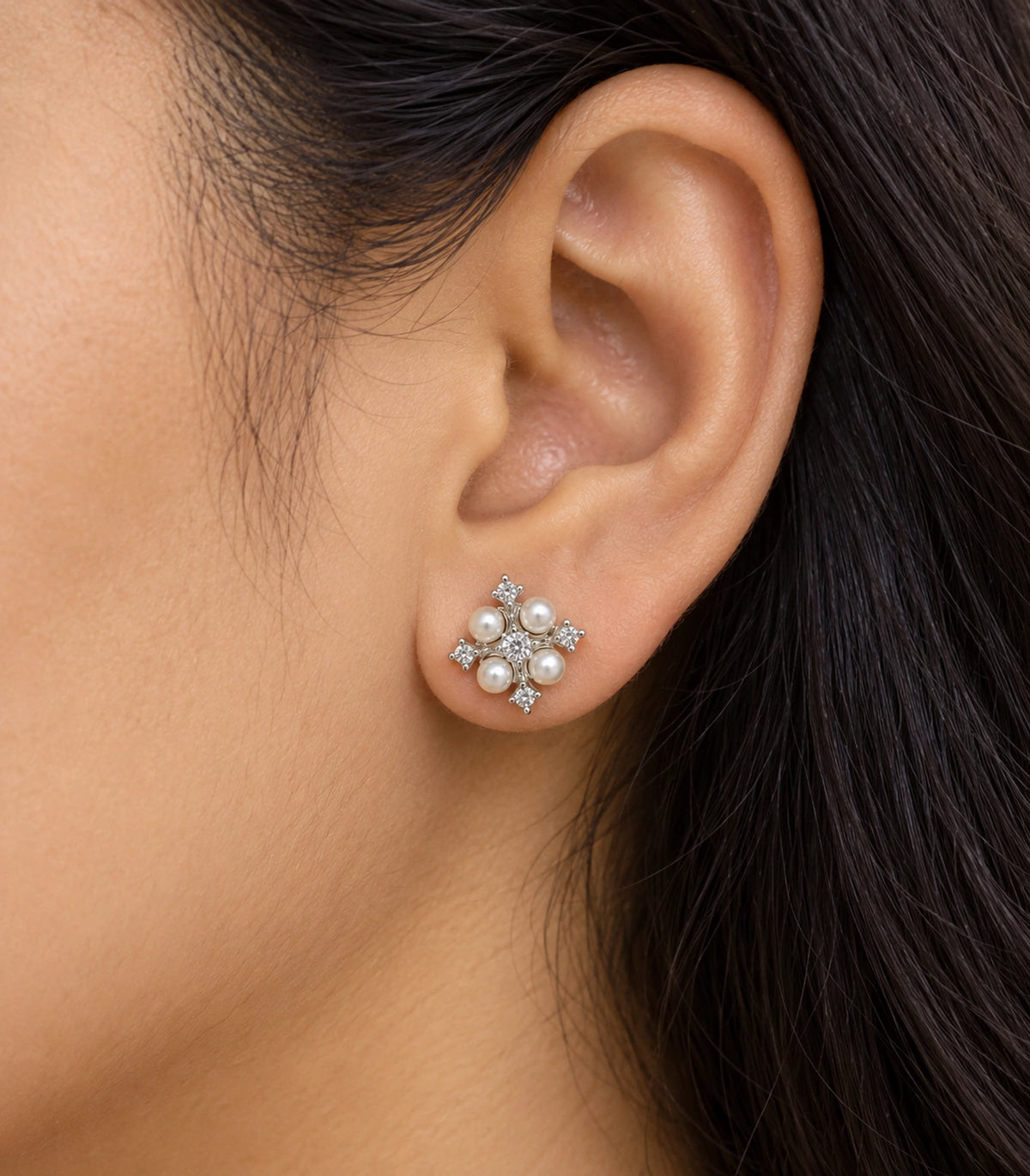 JIMIKI silver crystal pearl snowflake stud earrings, worn closeup showing design details #color_silver