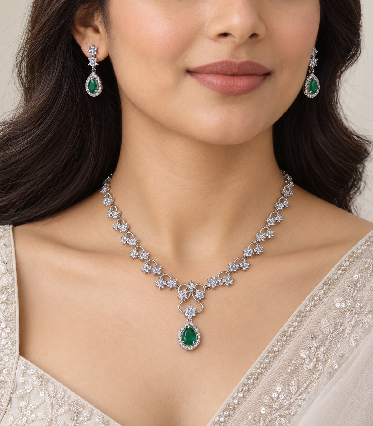 Silver Emerald Teardrop Crystal Necklace Set worn with a cream outfit