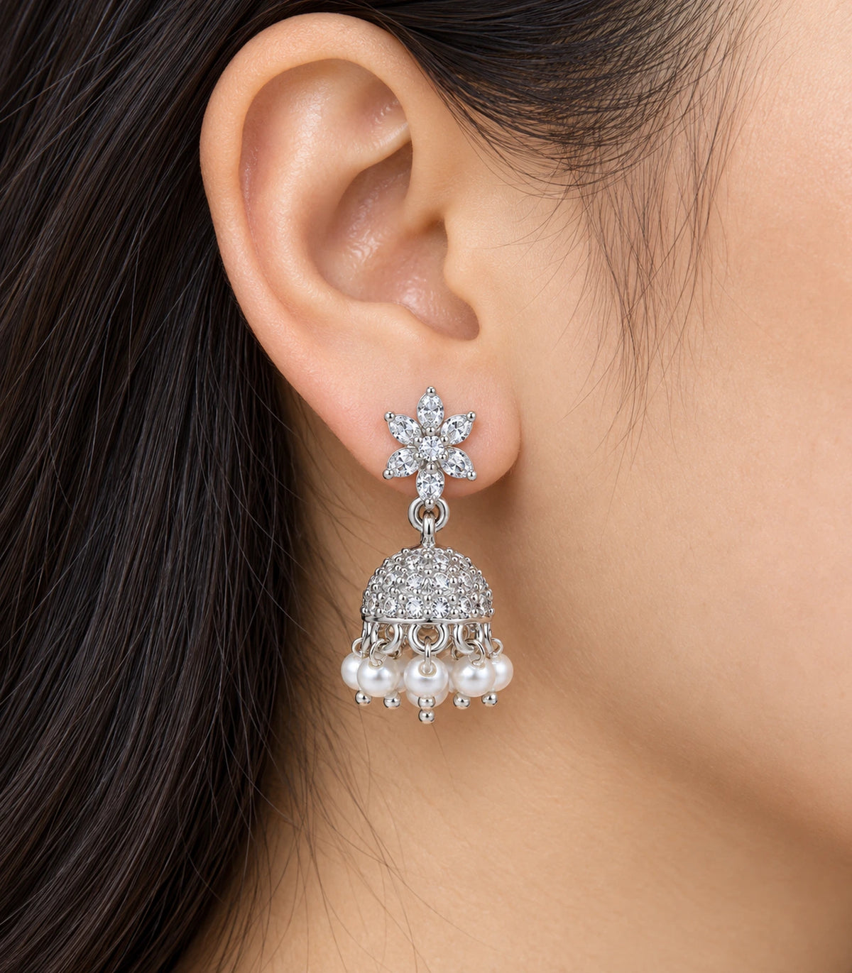 JIMIKI Silver Leaf Flower Crystal Jhumka Earrings - Worn close-up of six pointed petals and bead fringe #color_silver