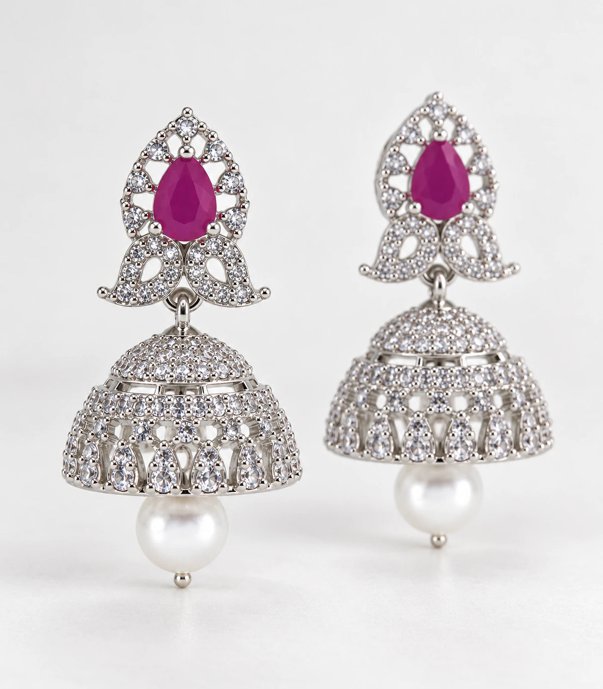 Matching magenta butterfly pearl-style jhumka earrings in an editorial product arrangement