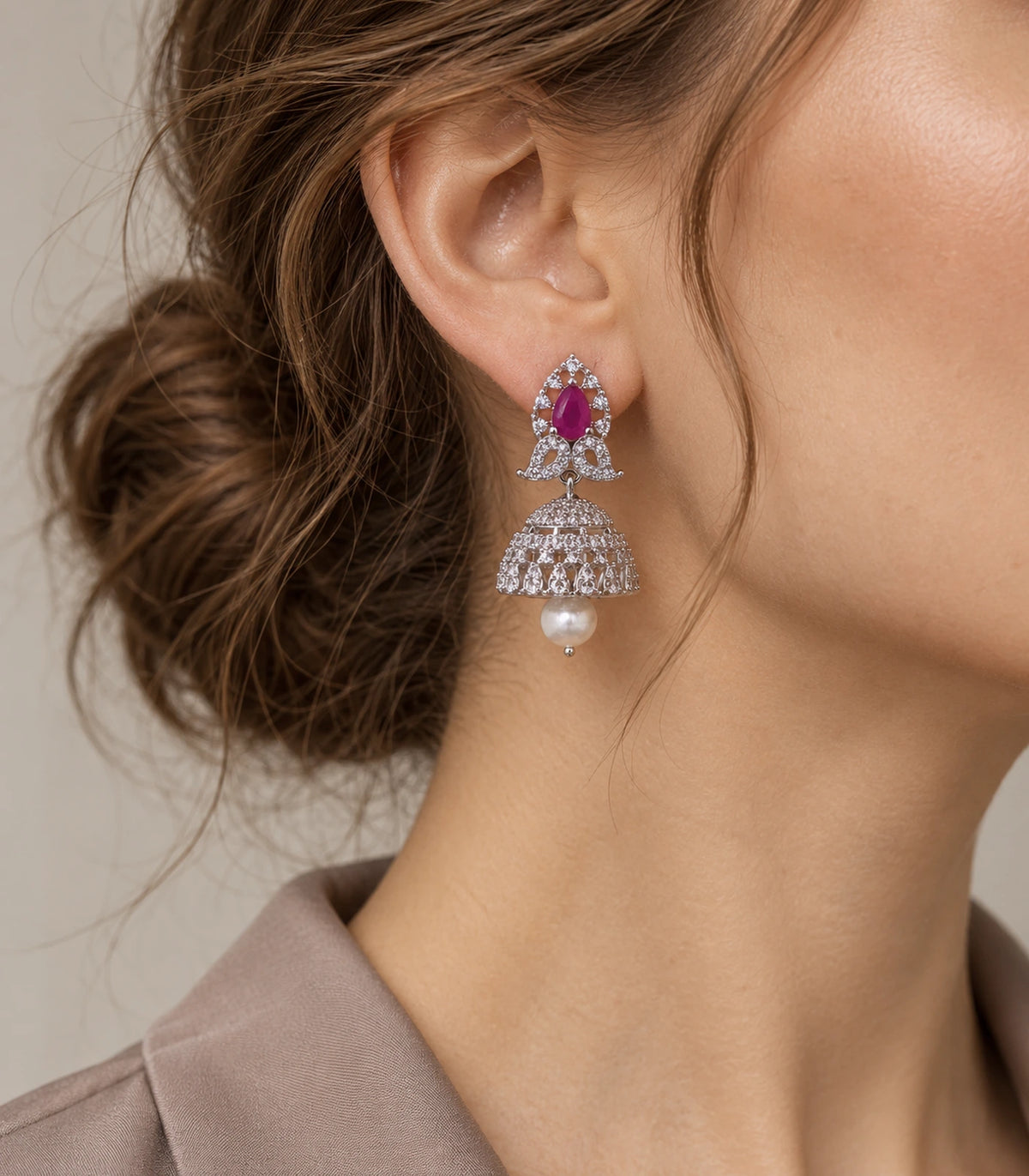 Magenta butterfly jhumka earring with a white pearl-style drop shown worn at the ear