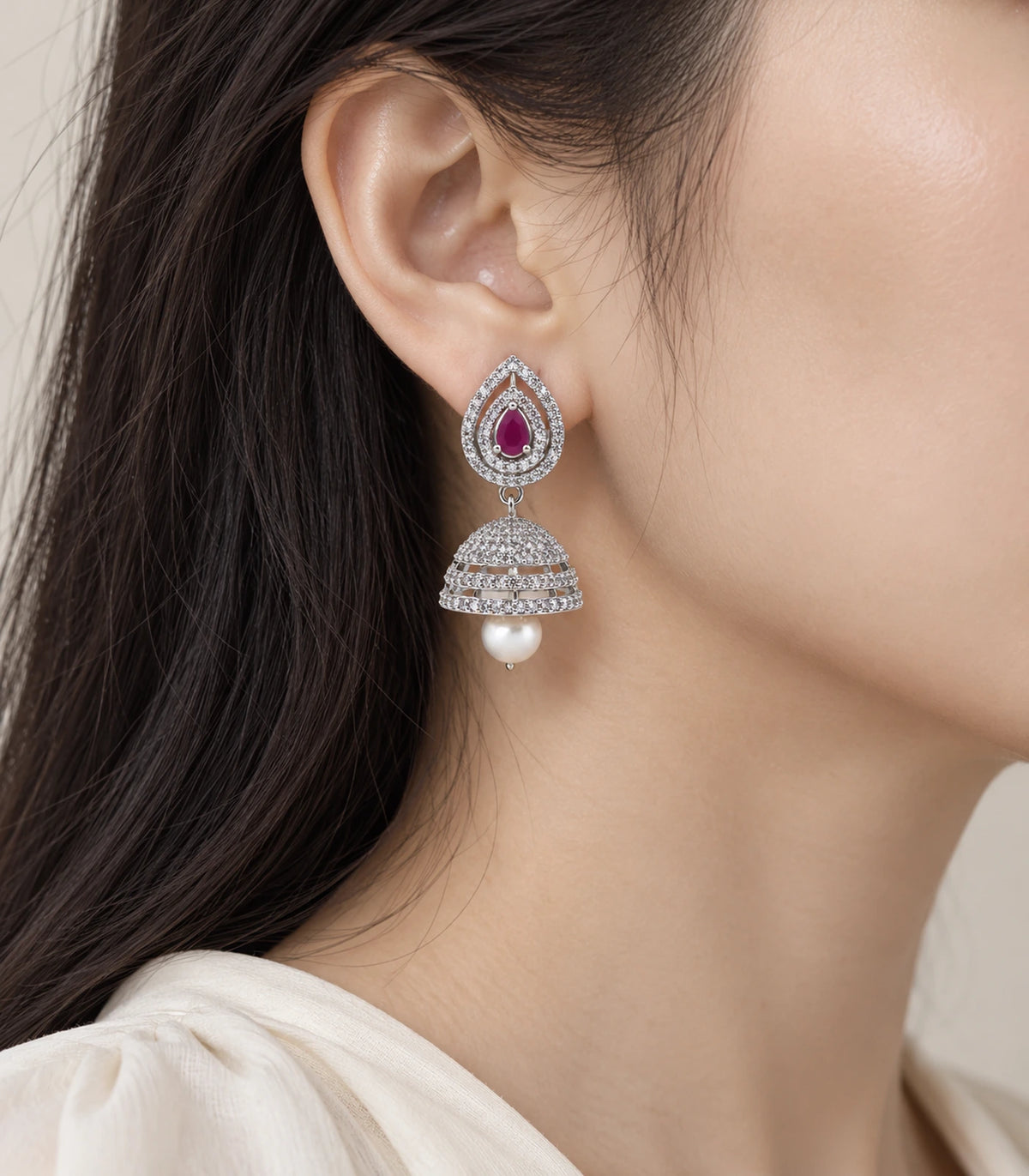 Silver-tone magenta double halo jhumka earring worn beside the face