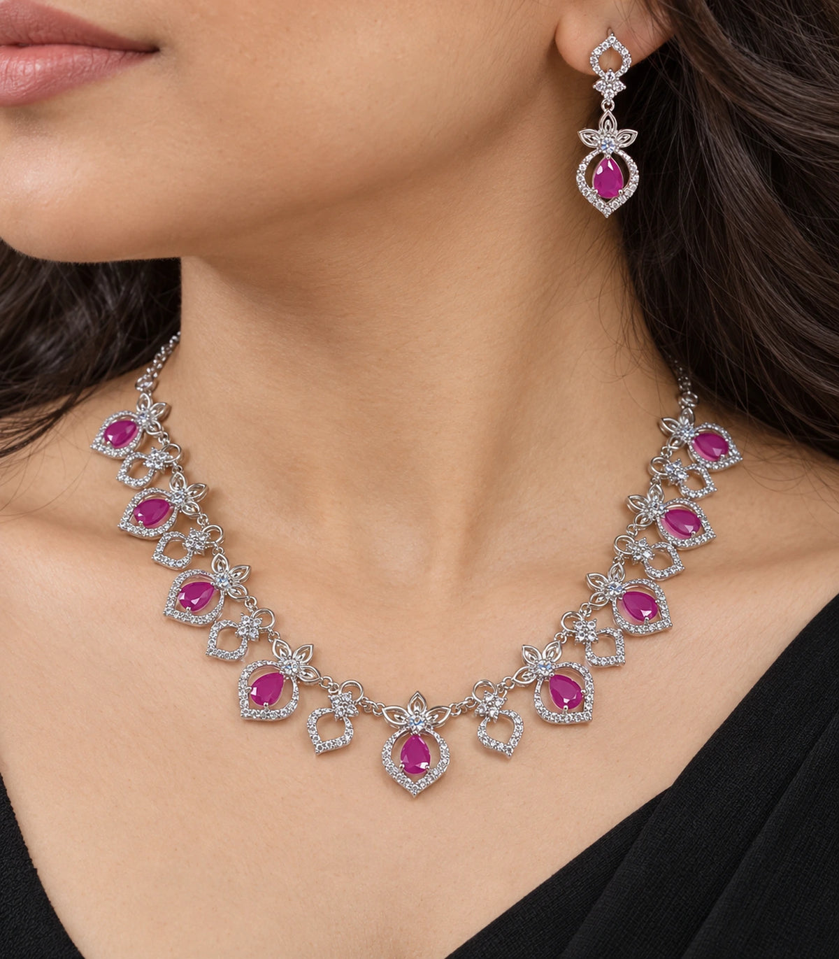 Close view of the magenta necklace and a matching drop earring worn