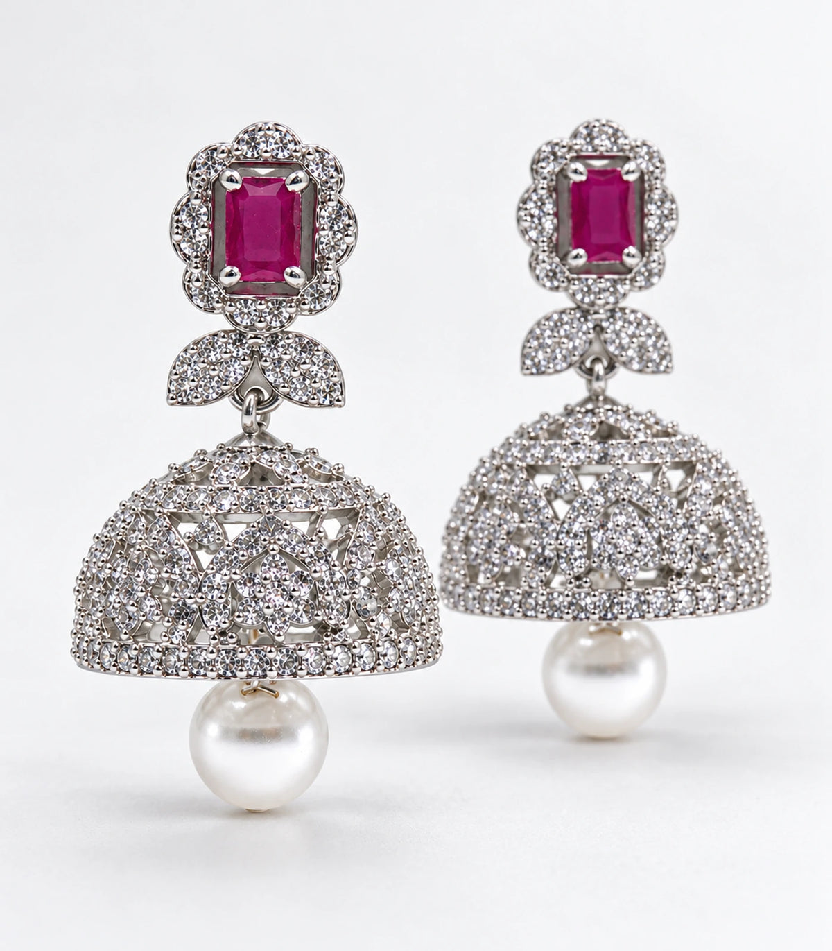Matching pair of silver-tone magenta rectangular bow pearl-style jhumka earrings in styled product view
