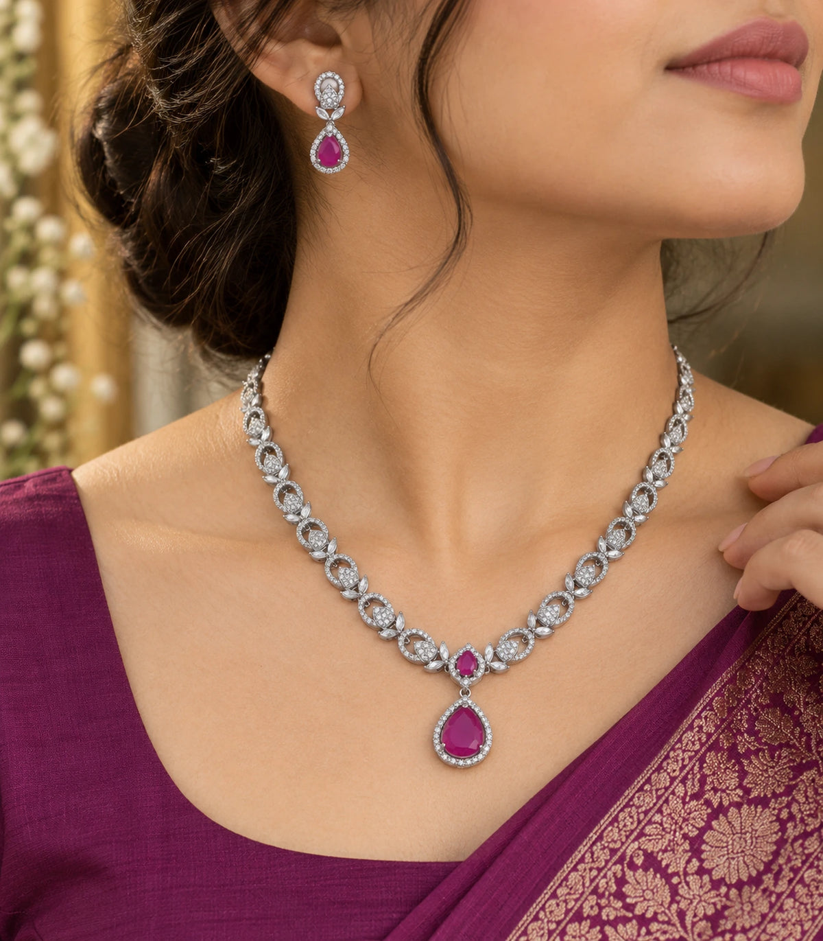 Three-quarter worn view of the silver-tone magenta necklace and matching earring