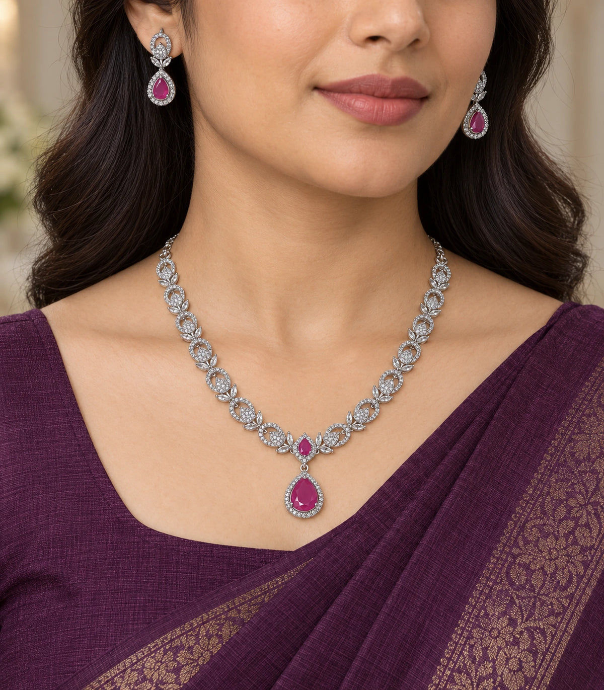 Magenta crystal necklace and matching earrings worn with a purple sari