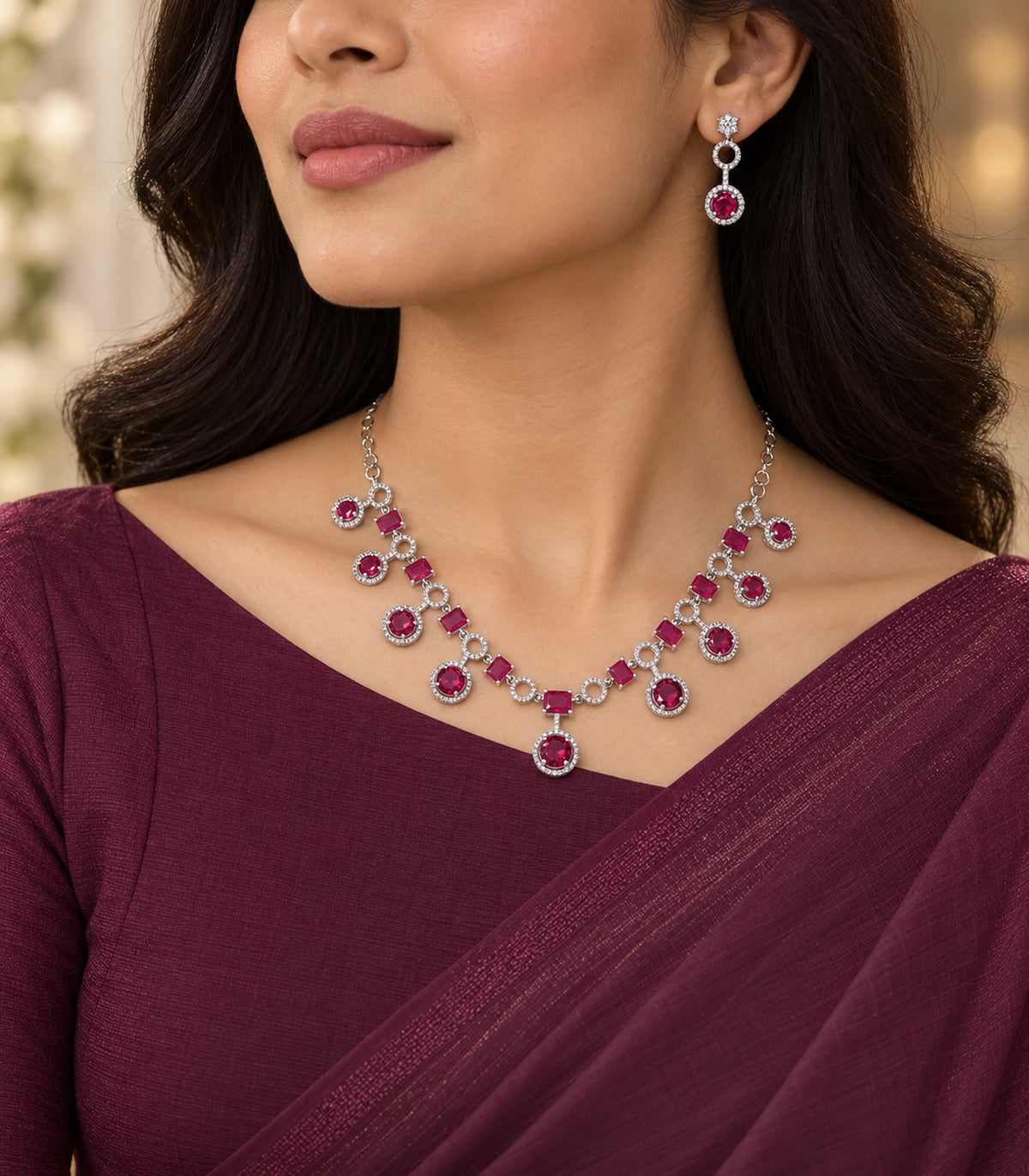 Silver-tone magenta necklace and matching earring worn with a burgundy outfit