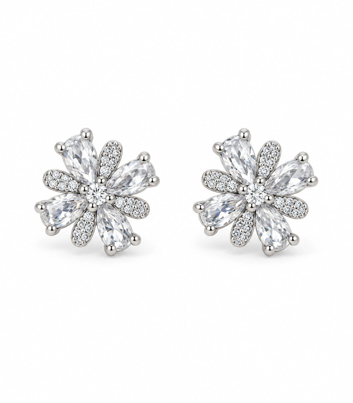 Matching pair of silver-tone floral stud earrings with clear faceted accents and pavé-style petals on white