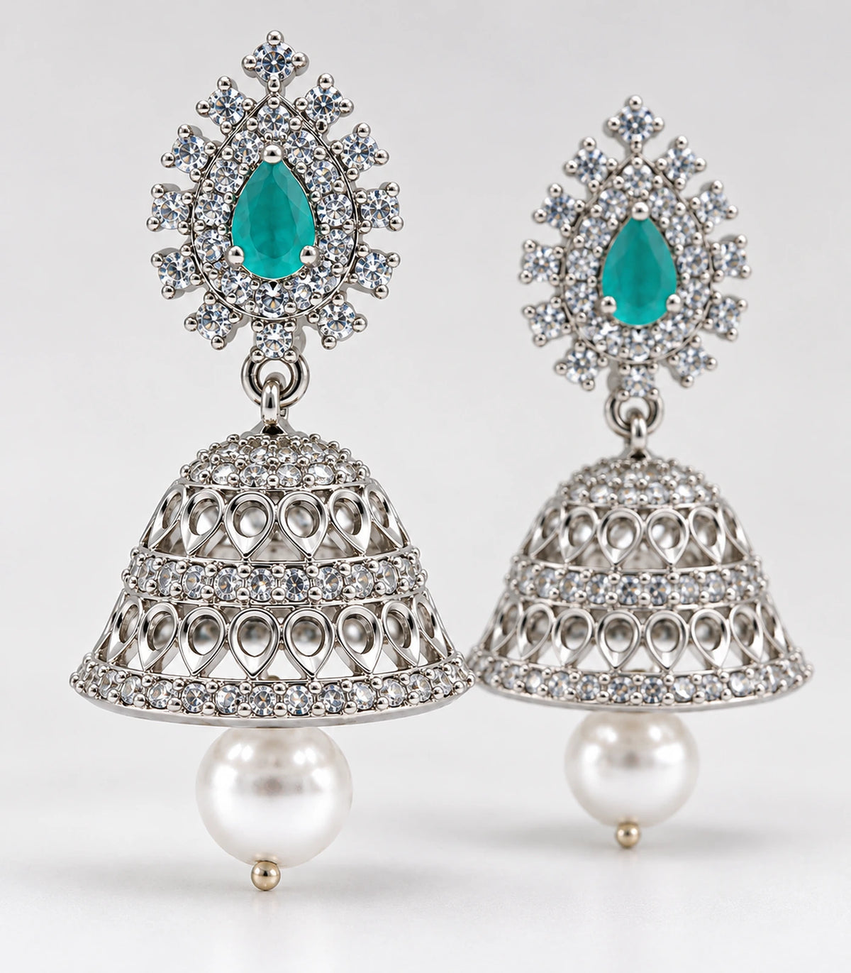 Matching pair of mint teardrop silver-tone jhumka earrings showing bell details and pearl-look drops
