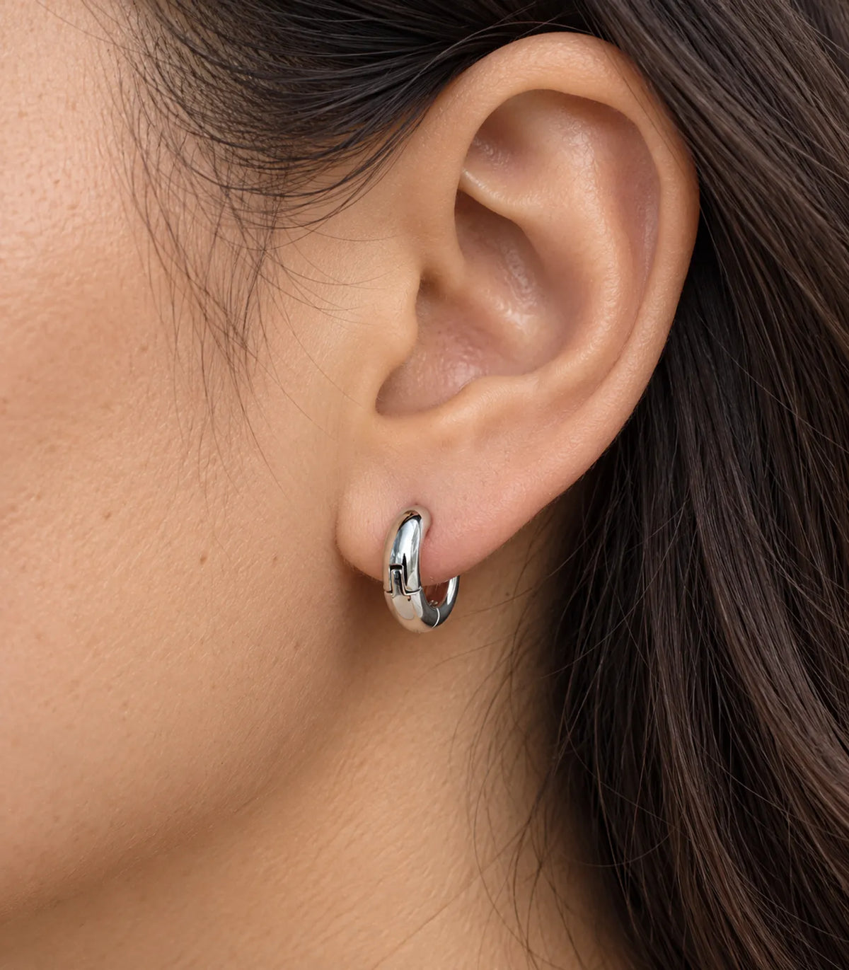 JIMIKI Silver Organic Polished Huggie Earrings — worn close-up detail #color_silver