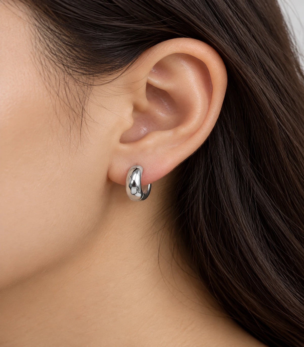 JIMIKI Silver Organic Polished Huggie Earrings — worn styling view #color_silver
