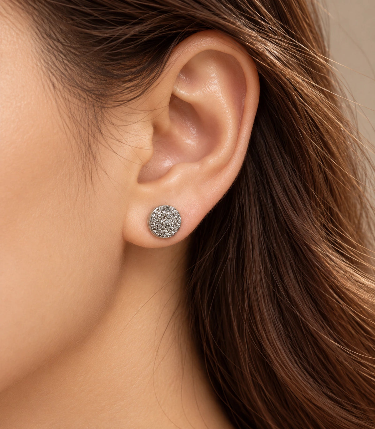 Silver-tone pavé disc stud earring worn in a distinct editorial ear detail