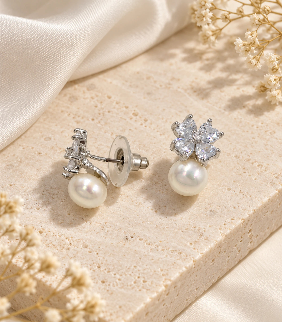 JIMIKI Silver Pear Crystal Flower Pearl Drop Earrings in Silver - editorial flatlay #color_silver