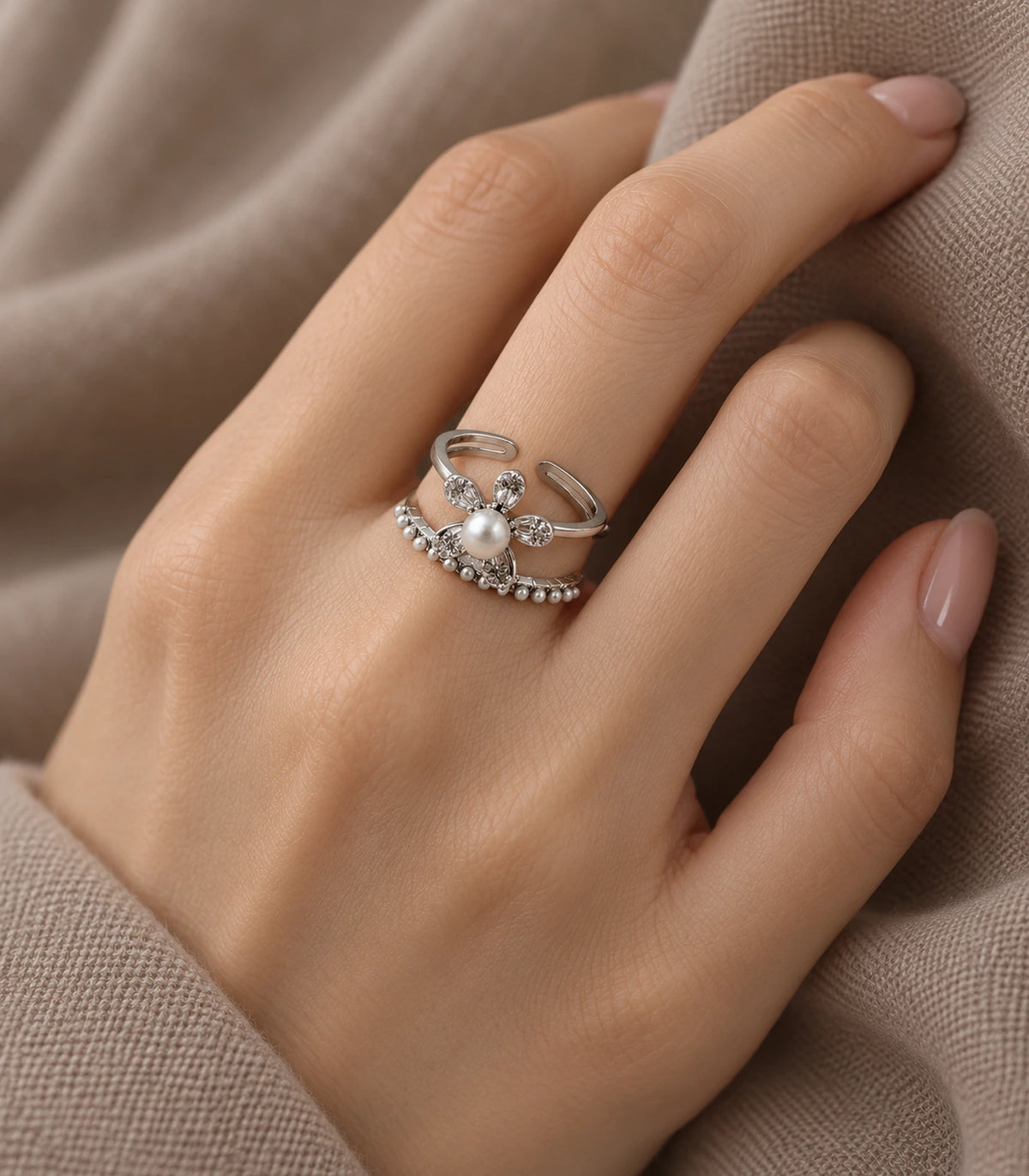 Silver-tone pearl flower fringe open ring worn with neutral fabric styling
