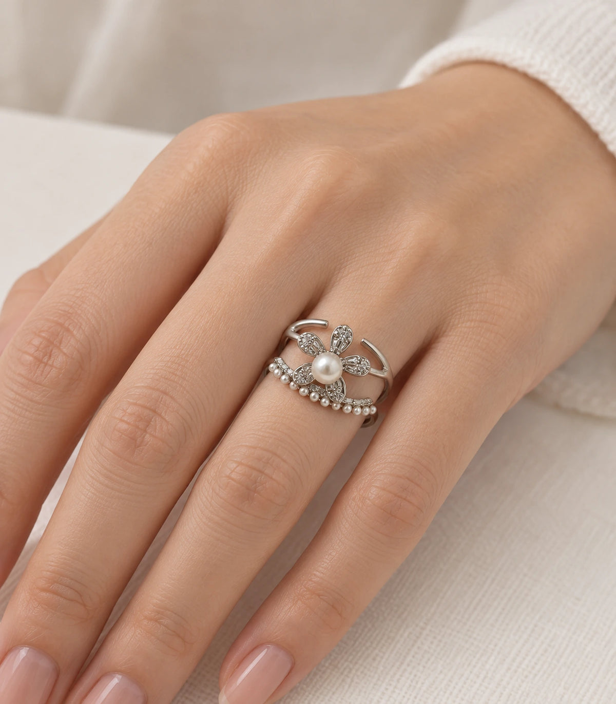 Silver-tone pearl flower fringe open ring worn on a hand