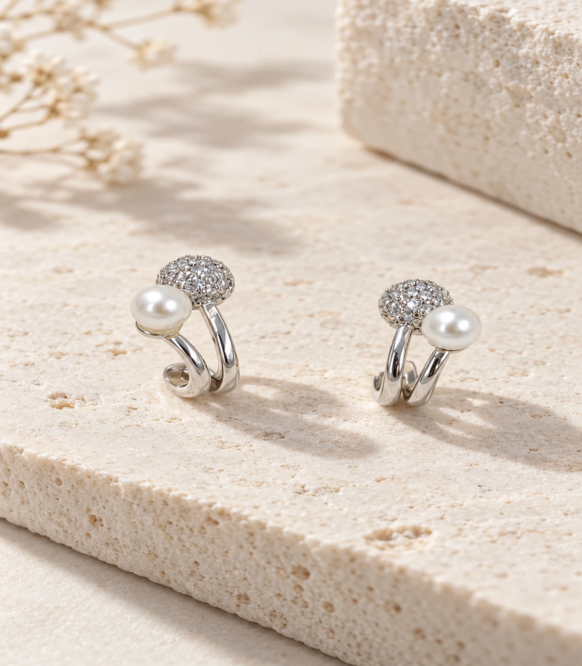 JIMIKI Silver Pearl Pave Disc Sculptural Earrings — editorial flat lay #color_silver