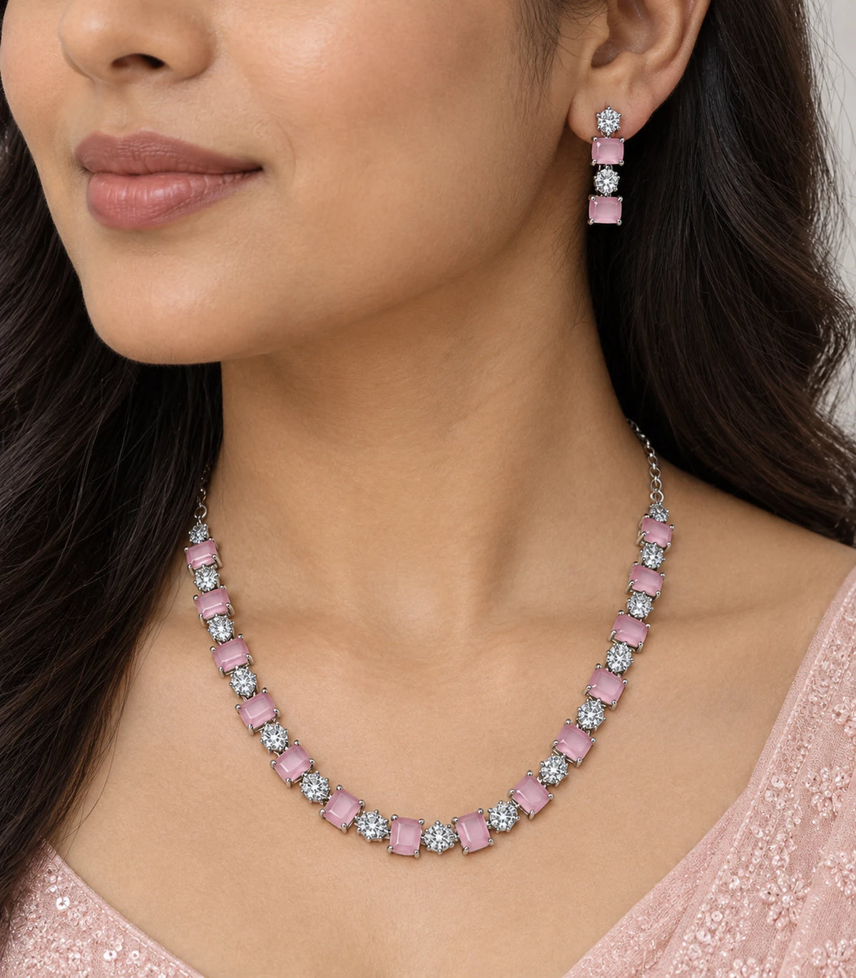 Closeup of the pink necklace and matching drop earring