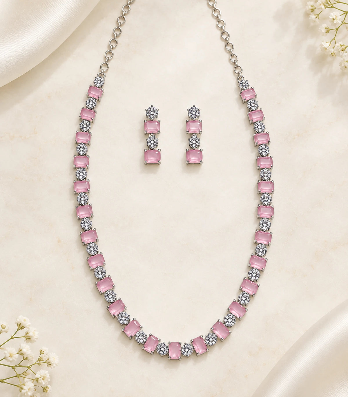 Silver Pink Square Crystal Necklace Set and matching pair of earrings in a styled flatlay