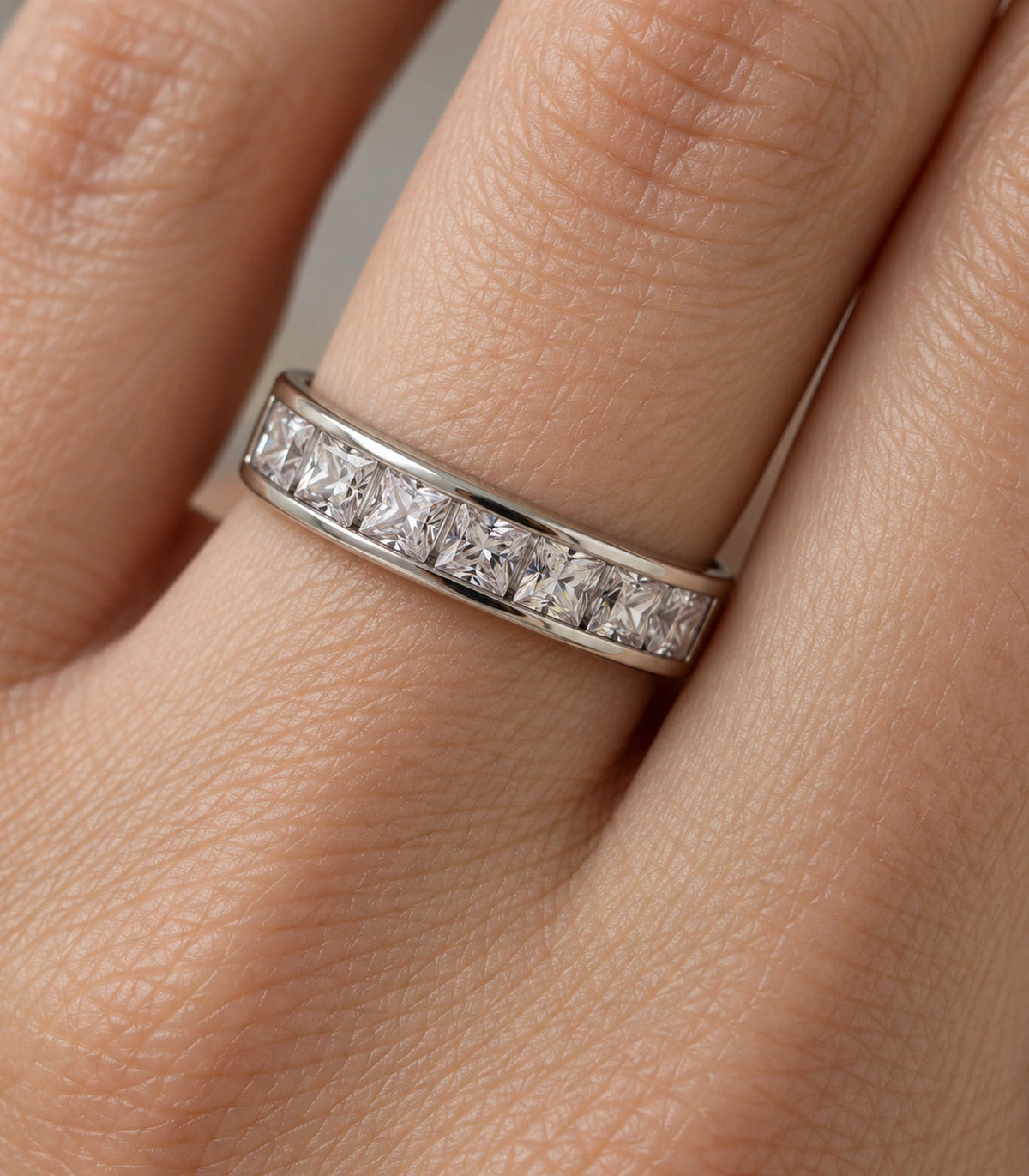 Close view of the square clear crystal channel row on a finger