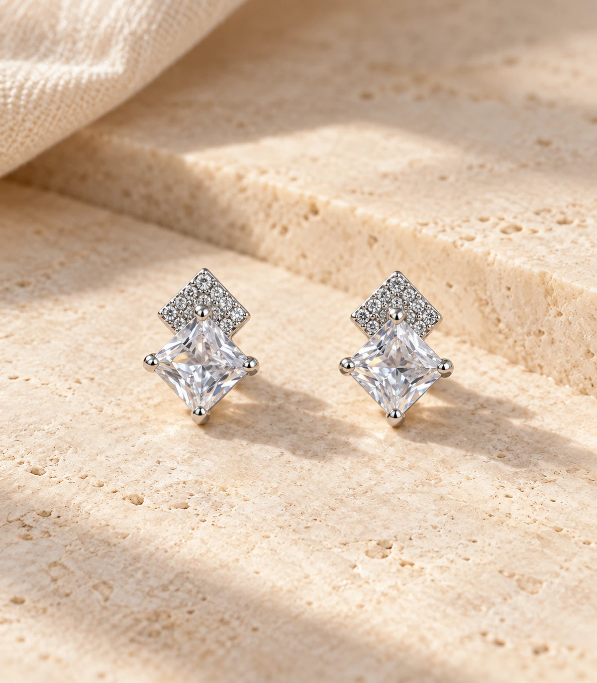 Matching Silver Princess Crystal Kite Stud Earrings arranged on a textured surface