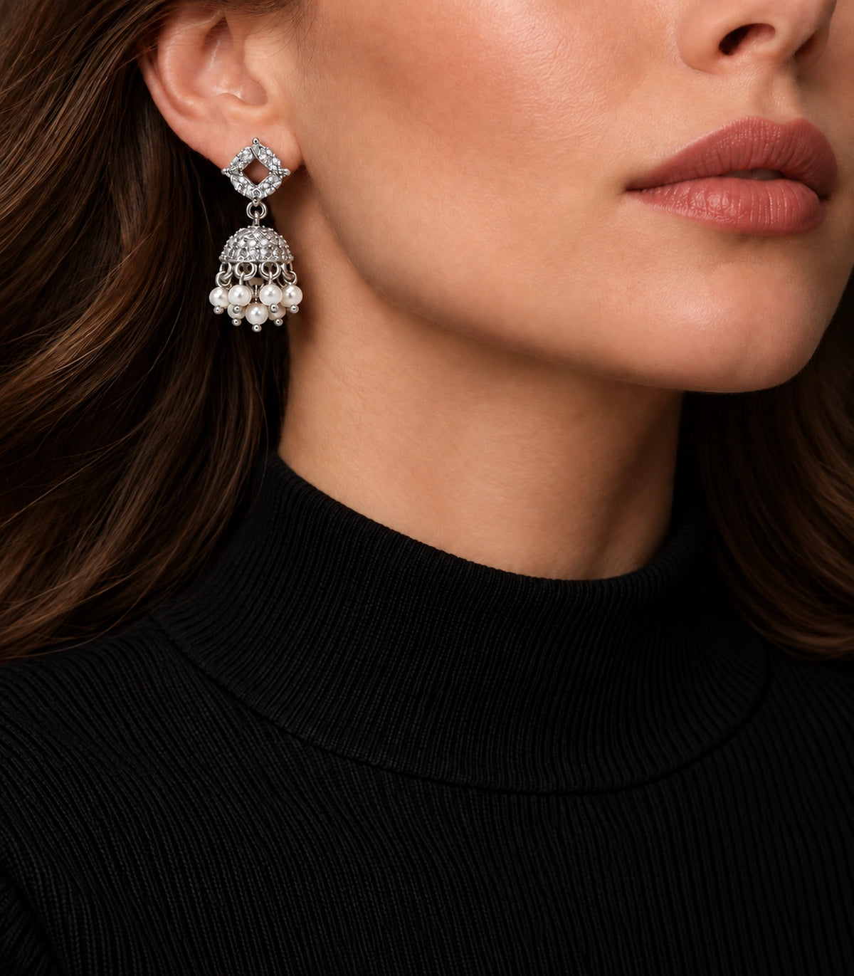 JIMIKI Silver Quatrefoil Crystal Jhumka Earrings - Earring styled with a black high-neck outfit #color_silver