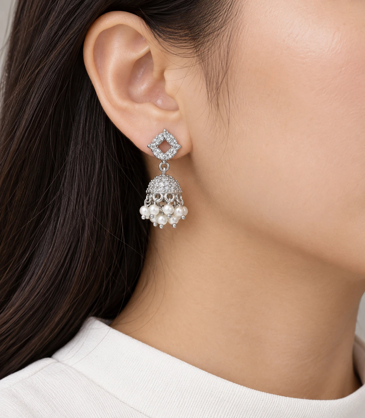 JIMIKI Silver Quatrefoil Crystal Jhumka Earrings - Earring worn with a white outfit #color_silver