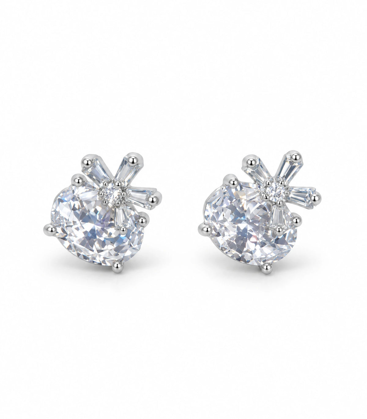 Pair of silver-tone round clear crystal-style stud earrings with baguette burst accents on white