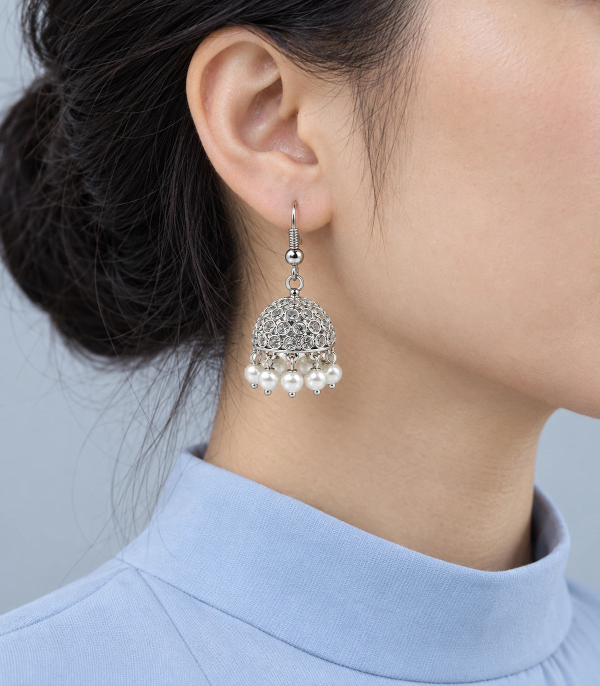 Silver-tone crystal-style and pearl-effect hook jhumka worn with a pale blue top #color_silver