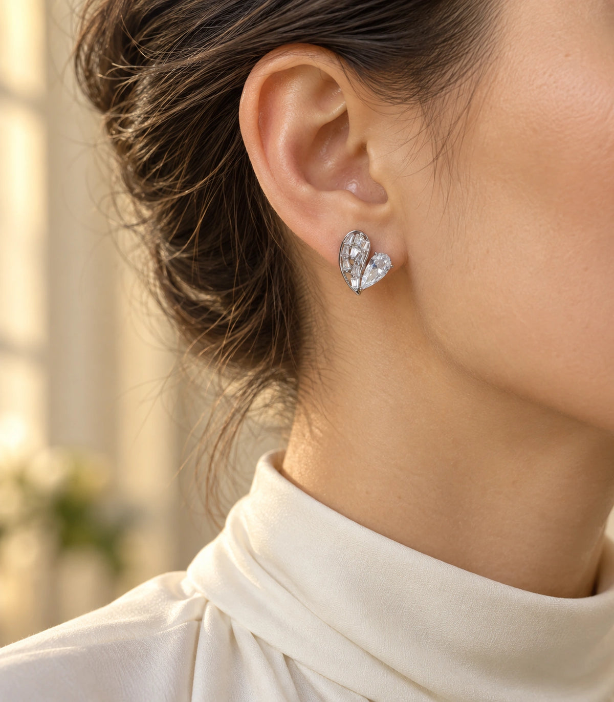 JIMIKI Asymmetric Crystal Heart Stud Earring Pair in Silver Tone, editorial model view #color_silver tone