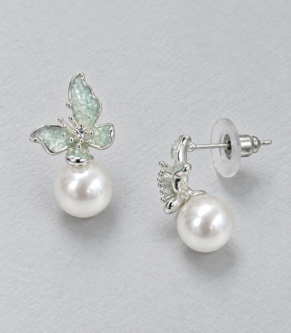 JIMIKI Asymmetric Butterfly Pearl-Style Earrings in Mint / silver-tone / white, editorial flat lay #color_mint / silver-tone / white