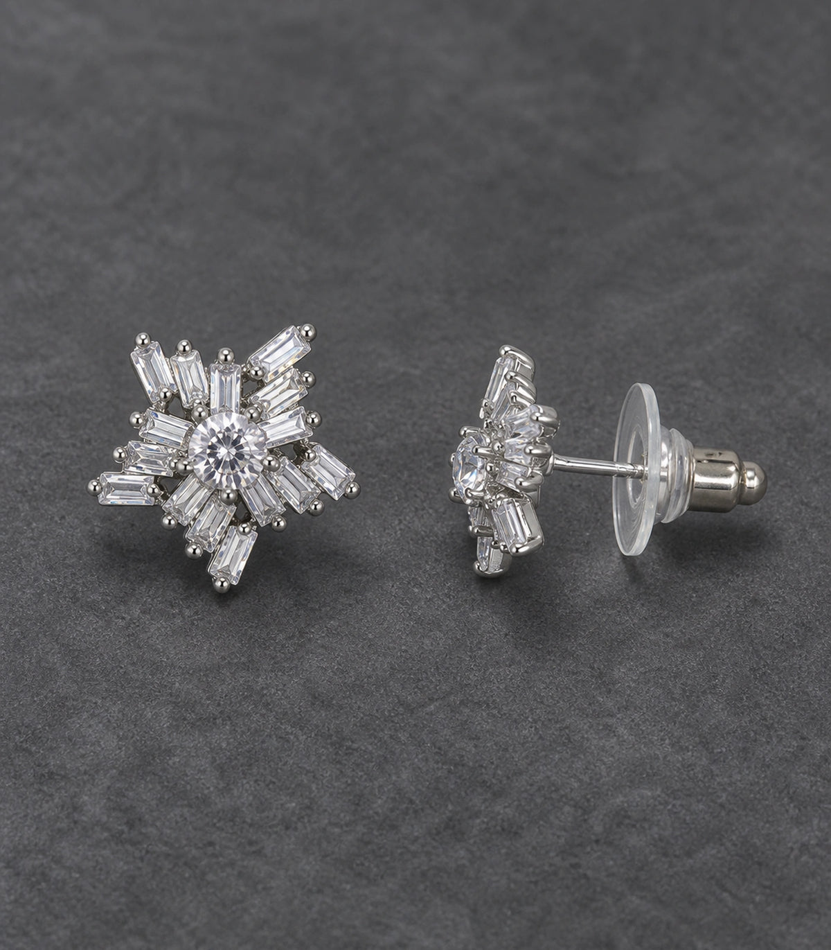JIMIKI Silver-Tone Baguette Starburst Stud Earrings in Silver / Clear, editorial flat lay