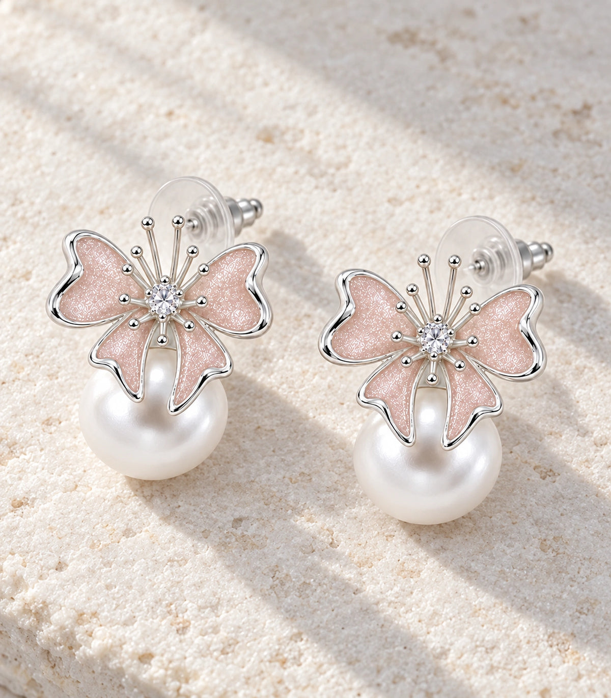 JIMIKI Butterfly Pearl Stud Earring Pair in Silver Tone / Blush, editorial flat lay #color_silver tone / blush