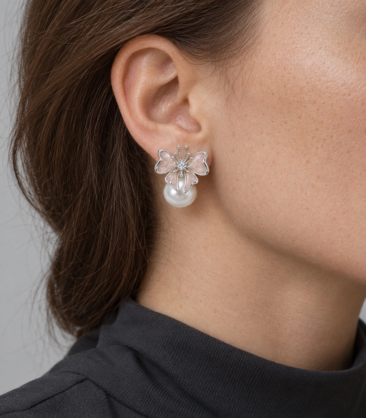JIMIKI Butterfly Pearl Stud Earring Pair in Silver Tone / Blush, model wearing view #color_silver tone / blush