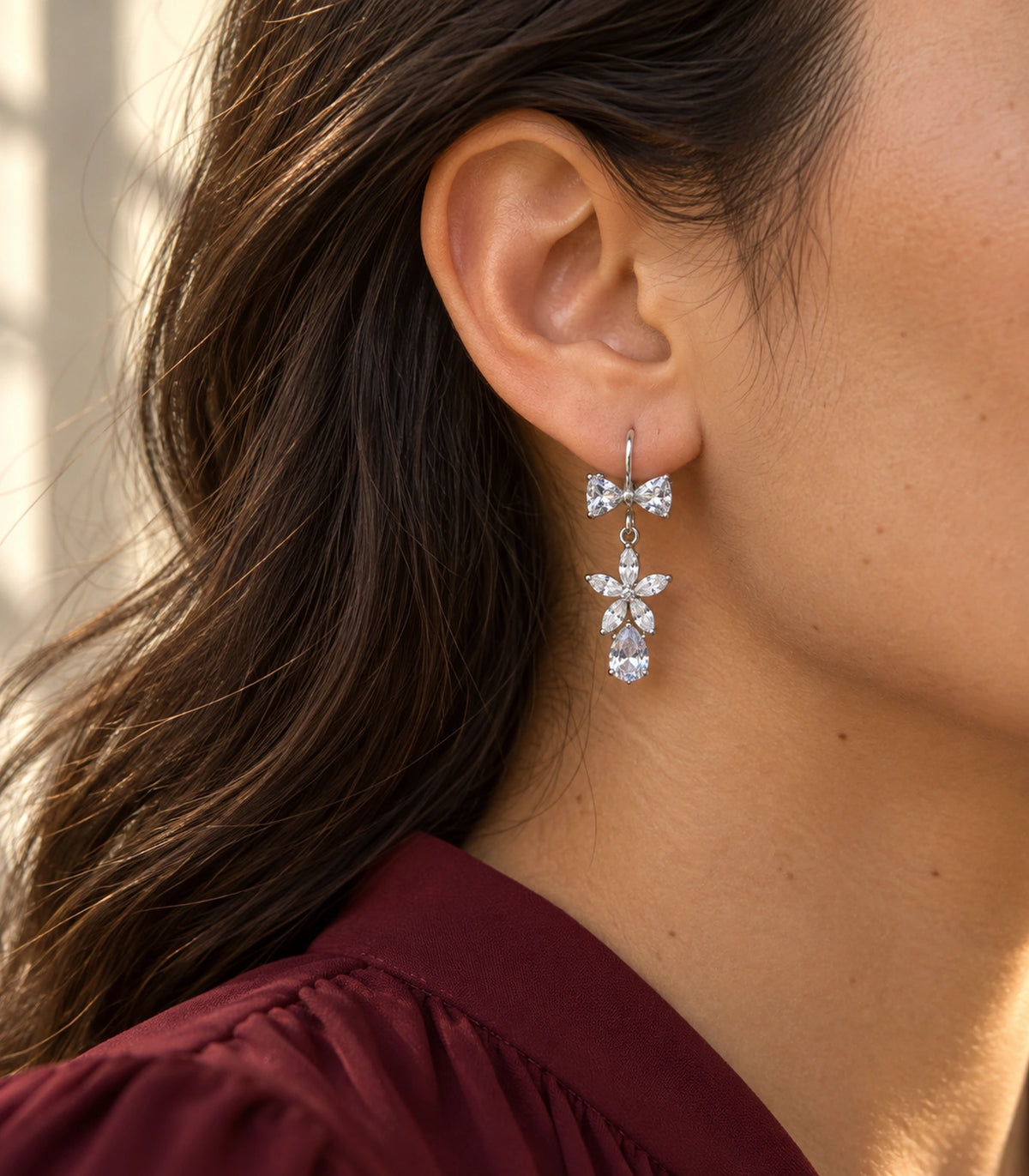 JIMIKI Silver-Tone Bow Flower Pear Drop Earrings in Silver-tone / clear, editorial model view