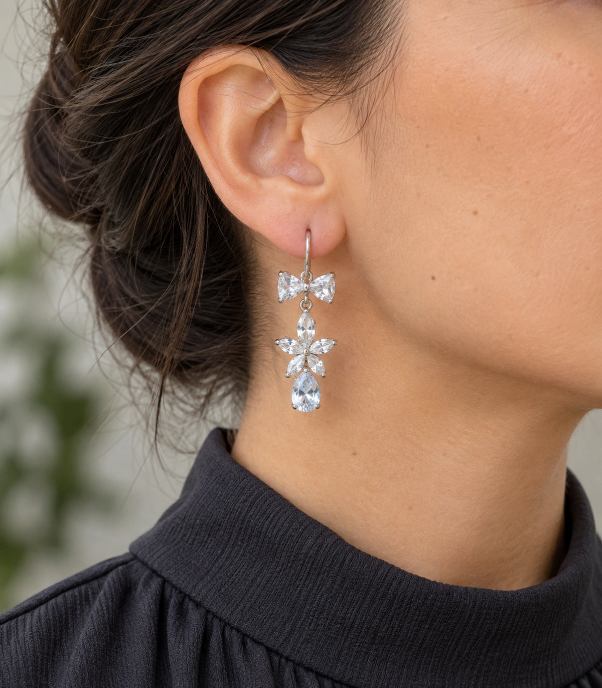 JIMIKI Silver-Tone Bow Flower Pear Drop Earrings in Silver-tone / clear, model wearing view