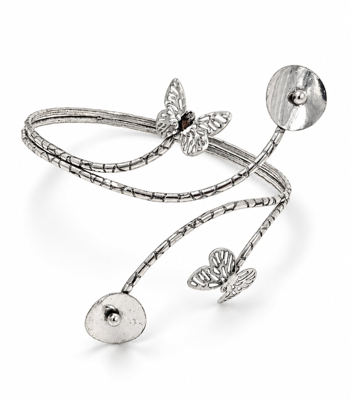 Silver-tone branching arm cuff with two cutout butterflies and two bead-centred discs on a white background