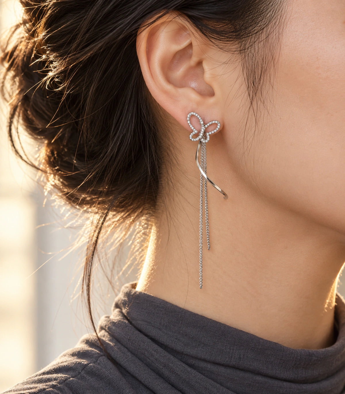 JIMIKI Butterfly Ribbon Chain Drop Earrings in Silver-tone, editorial model view #color_silver-tone