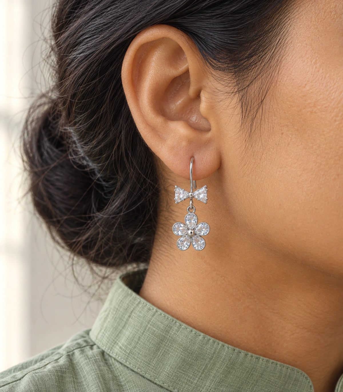 JIMIKI Silver Tone Clear Bow Five Petal Flower Drop Earring Pair in Silver tone / clear, editorial model view