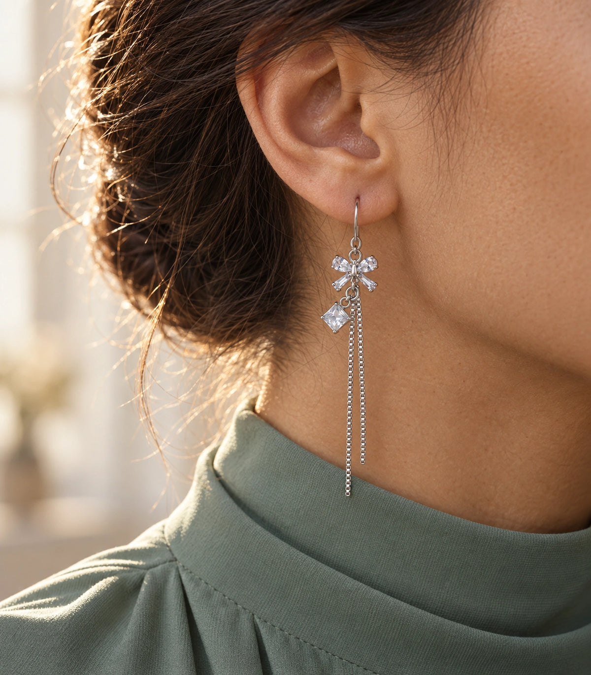 JIMIKI Silver Tone Clear Crystal Bow Square Chain Tassel Earring Pair in Silver tone / clear, editorial model view