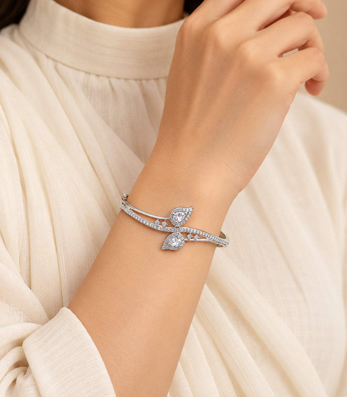 Silver-tone clear double leaf bangle styled on a wrist