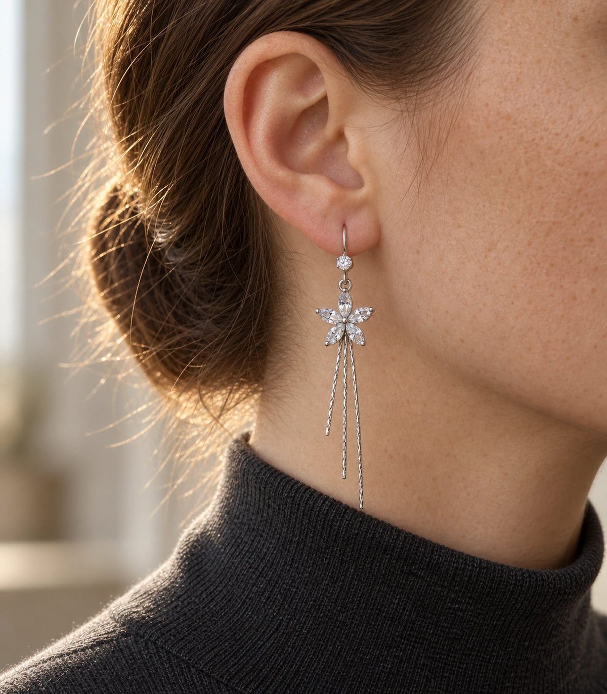 JIMIKI Silver Tone Clear Five Petal Flower Chain Tassel Earring Pair in Silver tone / clear, editorial model view