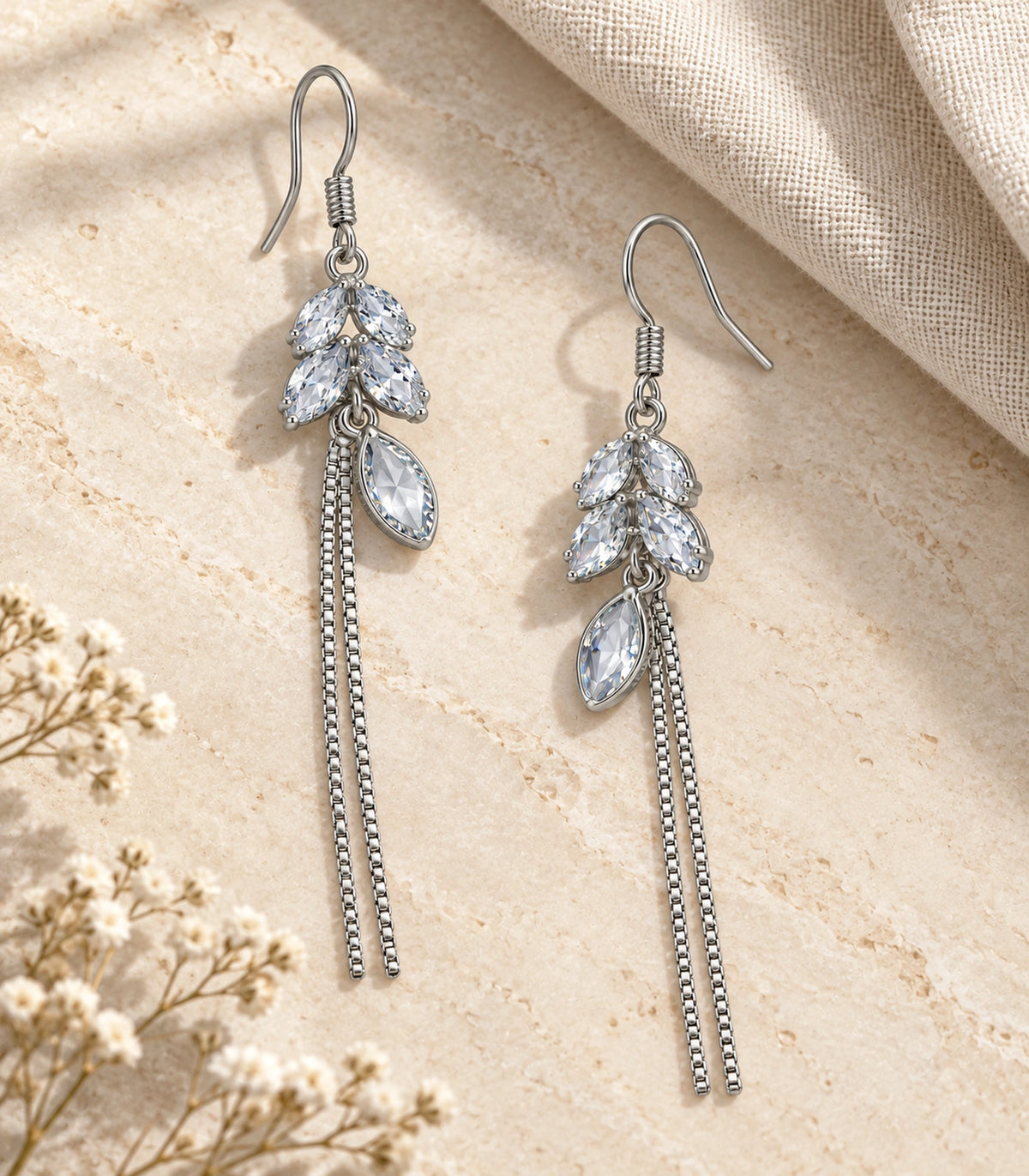 JIMIKI Silver Tone Clear Leaf Cluster Chain Tassel Earring Pair in Silver tone / clear, editorial flat lay