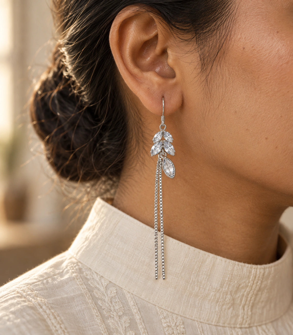 JIMIKI Silver Tone Clear Leaf Cluster Chain Tassel Earring Pair in Silver tone / clear, editorial model view