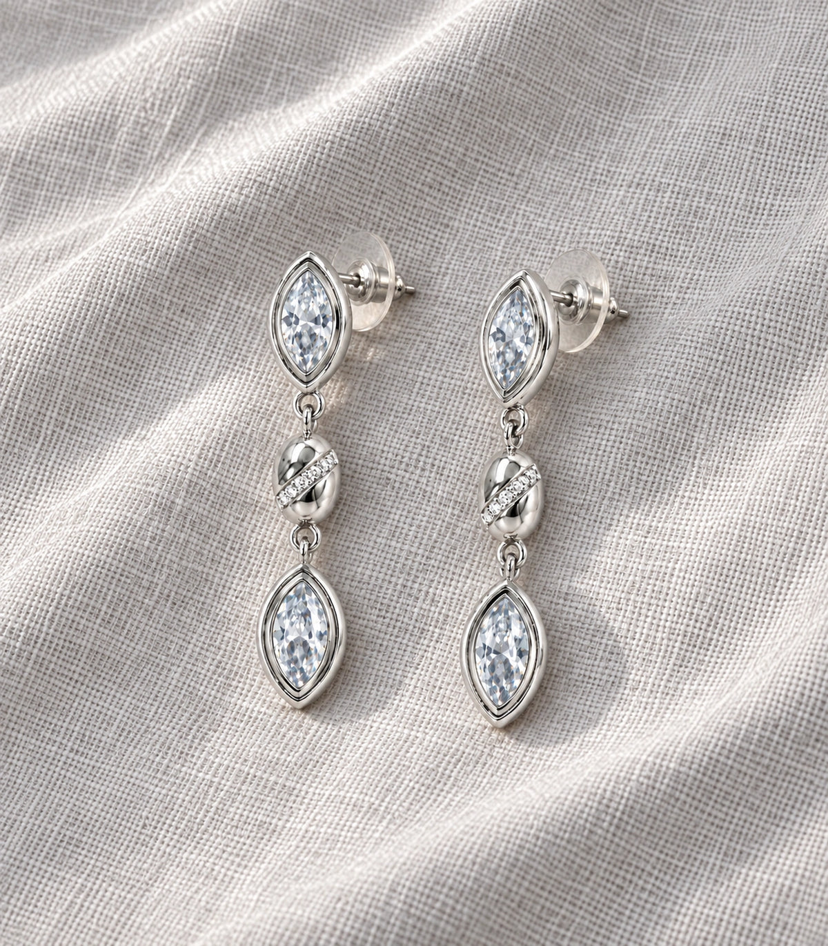 JIMIKI Marquise Crystal Oval Link Drop Earring Pair in Silver-tone, editorial flat lay #color_silver-tone