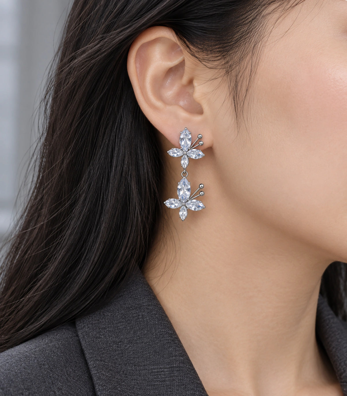 JIMIKI Silver Tone Clear Marquise Double Butterfly Drop Earring Pair in Clear / Silver, editorial model view