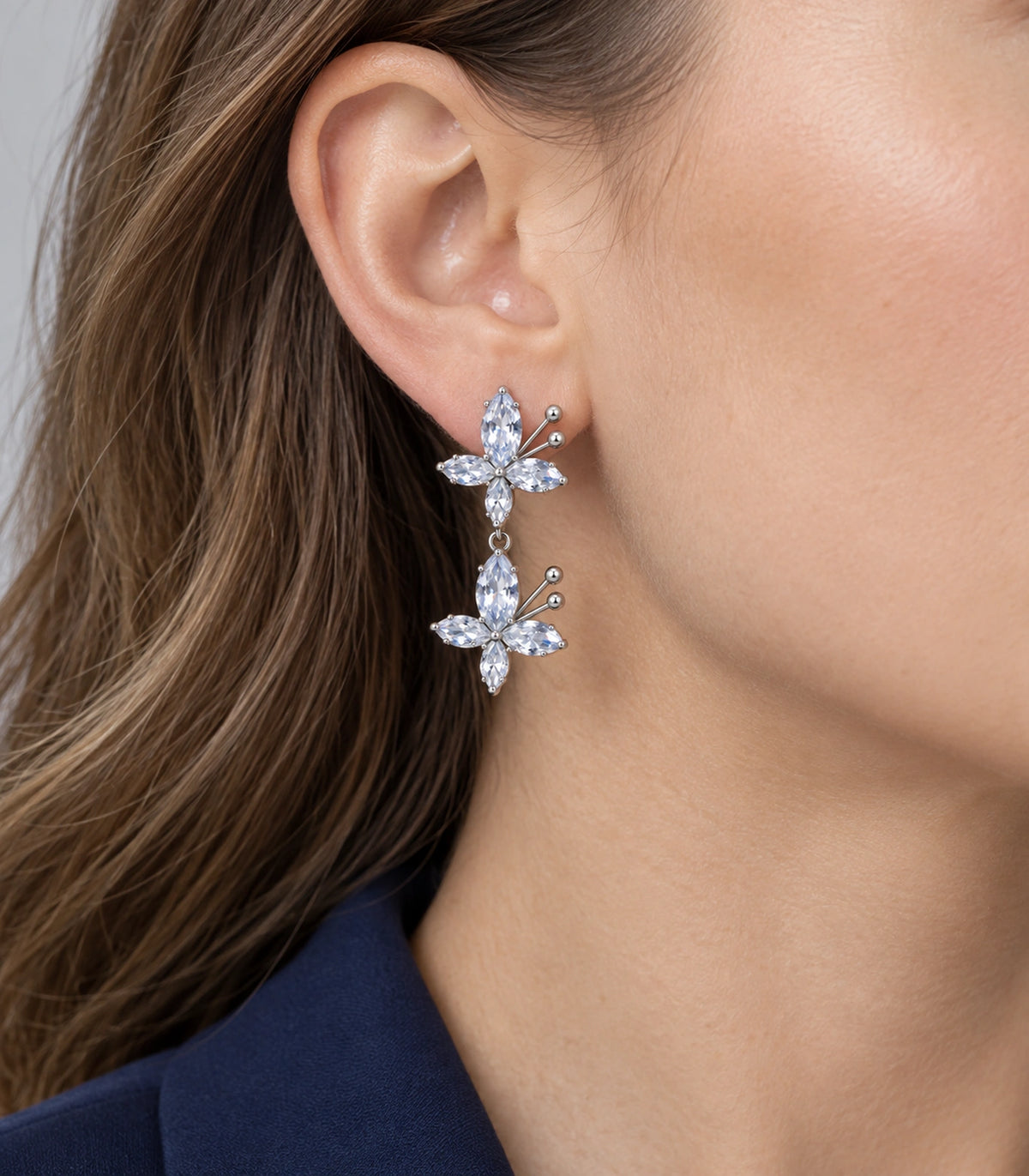 JIMIKI Silver Tone Clear Marquise Double Butterfly Drop Earring Pair in Clear / Silver, model wearing view